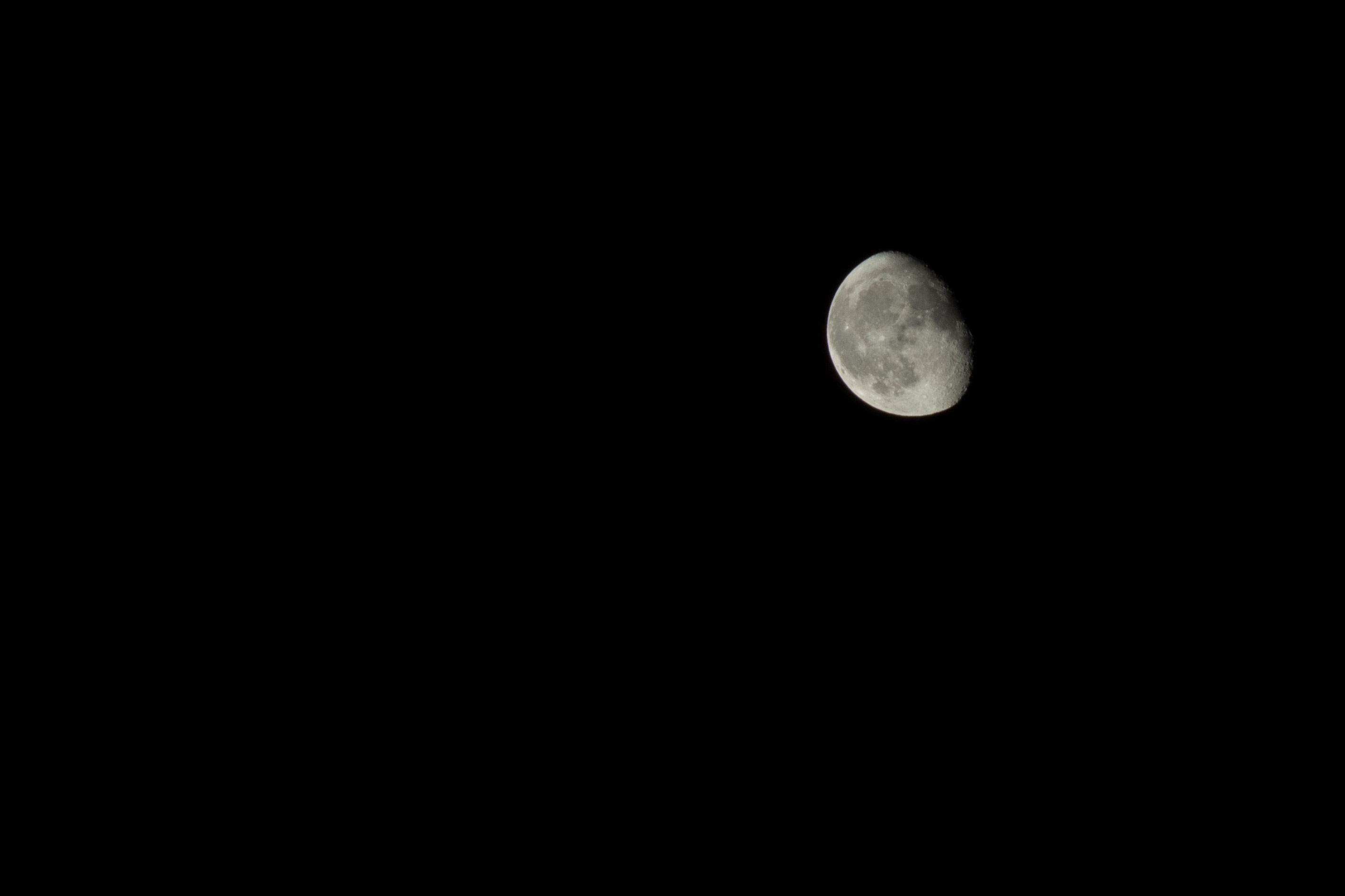 Gibbous moon in a pitch black sky