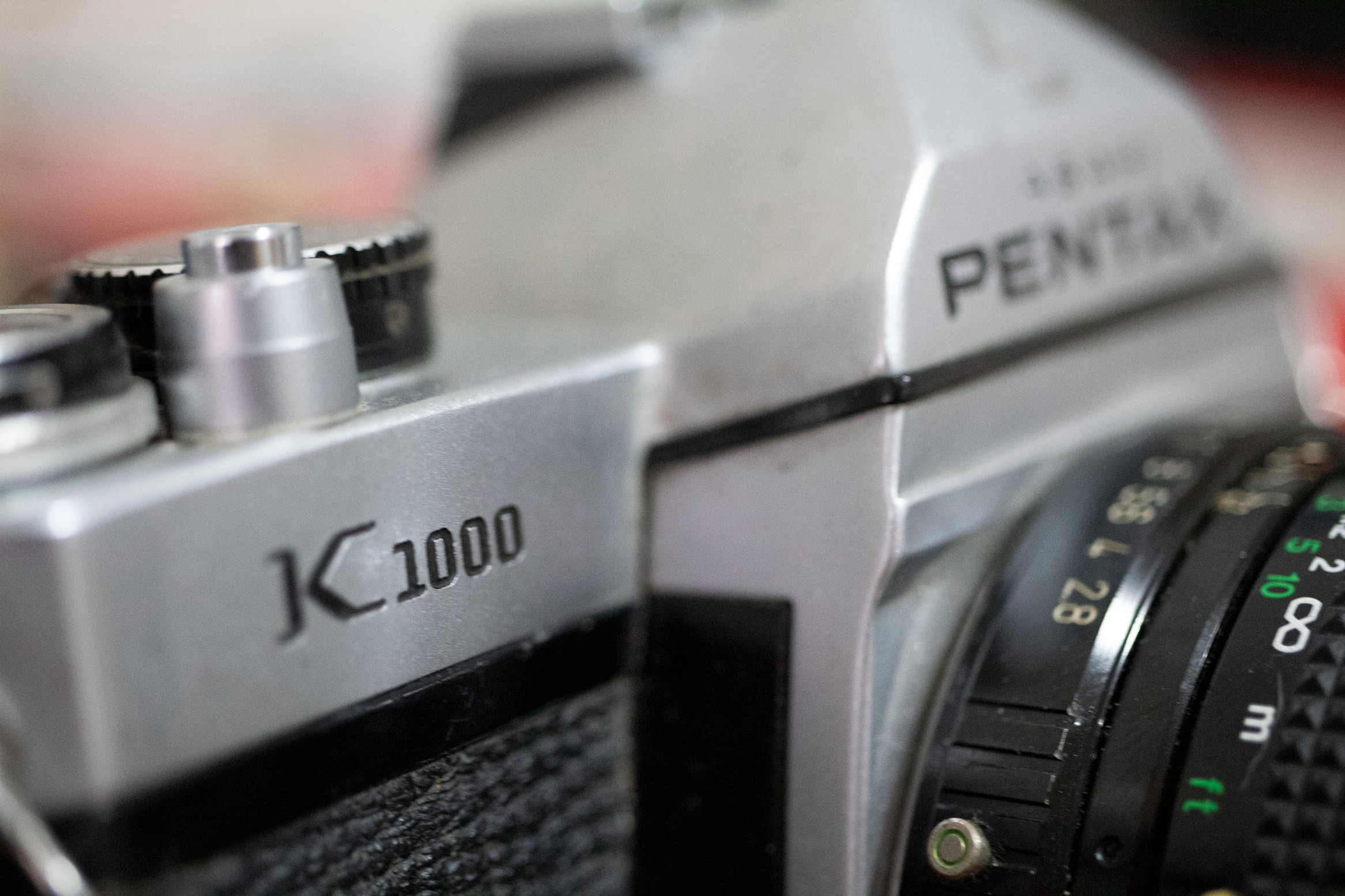 Closeup of a Pentax K1000 with a very narrow depth of field focused on the K1000 logo